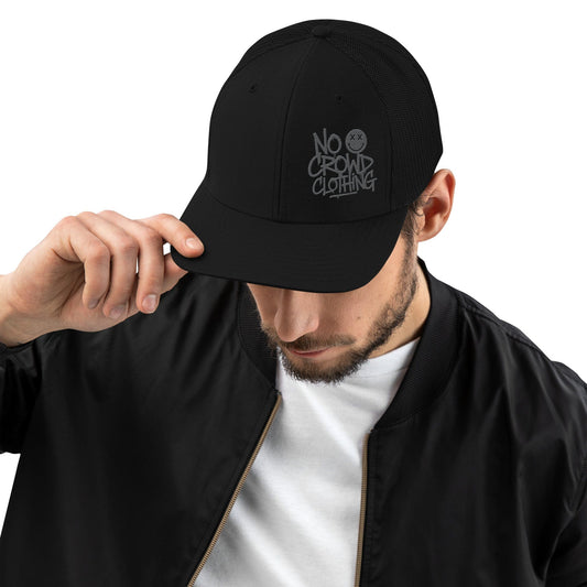 Black trucker hat with mesh back and structured front, designed by No Crowd Clothing, displayed on a plain background...front male model