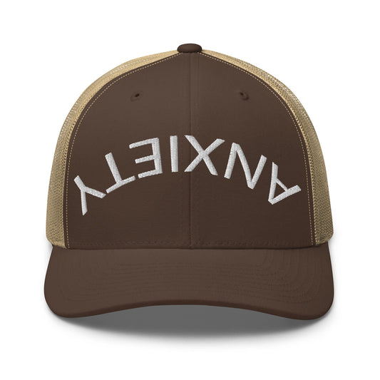 No Crowd Clothing's 'Upside Down Anxiety' hat features the word 'ANXIETY' upside down, symbolizing the chaos of anxiety. A reminder that with humor and strength, you can flip those overwhelming feelings right side up...brown