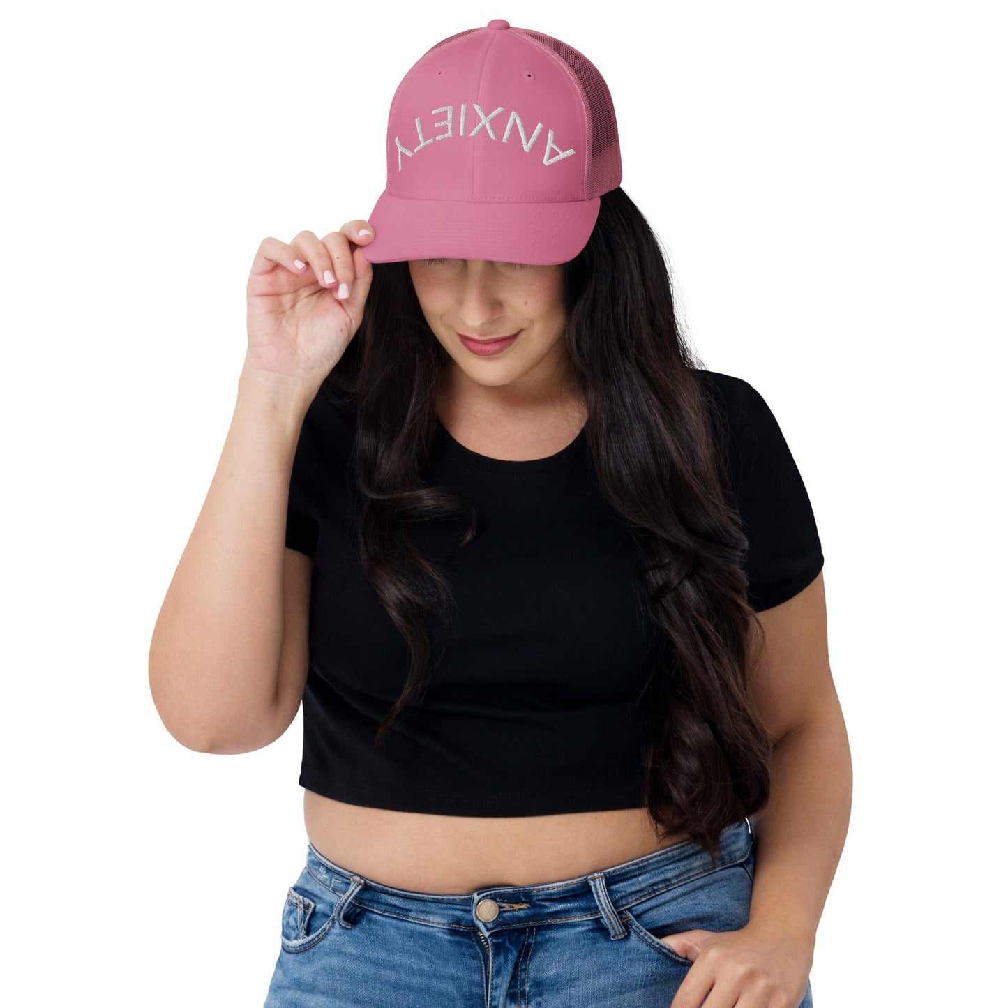 No Crowd Clothing's 'Upside Down Anxiety' hat features the word 'ANXIETY' upside down, symbolizing the chaos of anxiety. A reminder that with humor and strength, you can flip those overwhelming feelings right side up...pink model