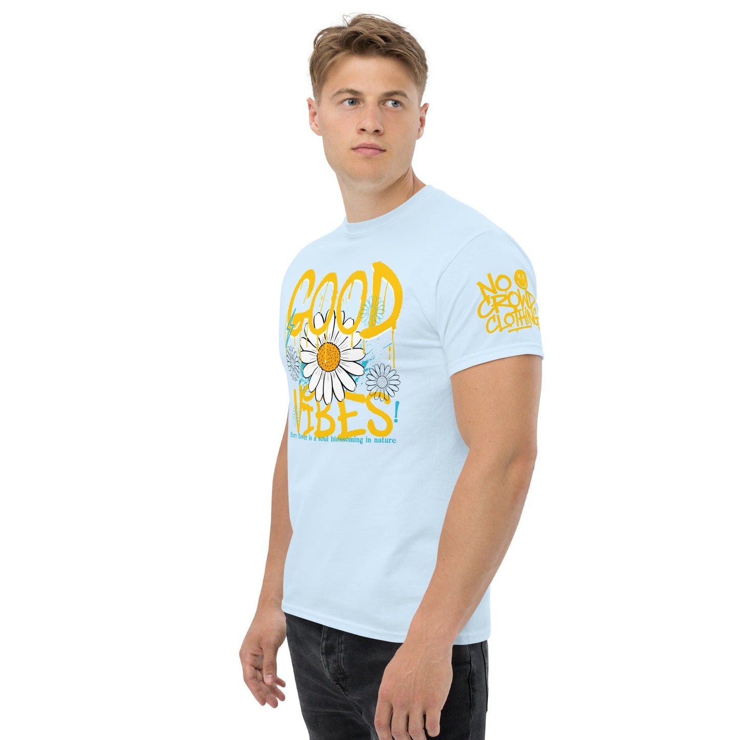 "Good Vibes" graphic tee with bold graffiti-style text, daisy flower design, and splashes of blue, promoting positivity and happiness to reduce anxiety...blue model