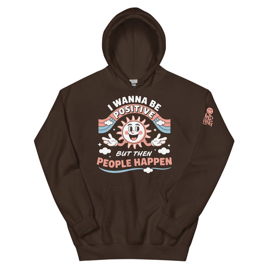 Brown hoodie with a retro smiling sun design and the funny phrase “I Wanna Be Positive But Then People Happen,” featuring vintage-style colors and clouds.