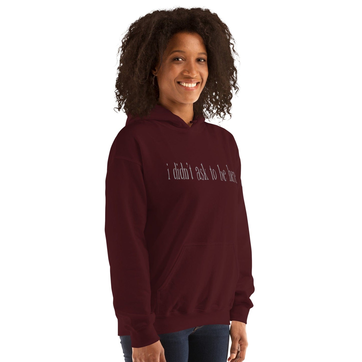 Hoodie with “I didn’t ask to be here” text minimalist introvert clothing design...maroon front model