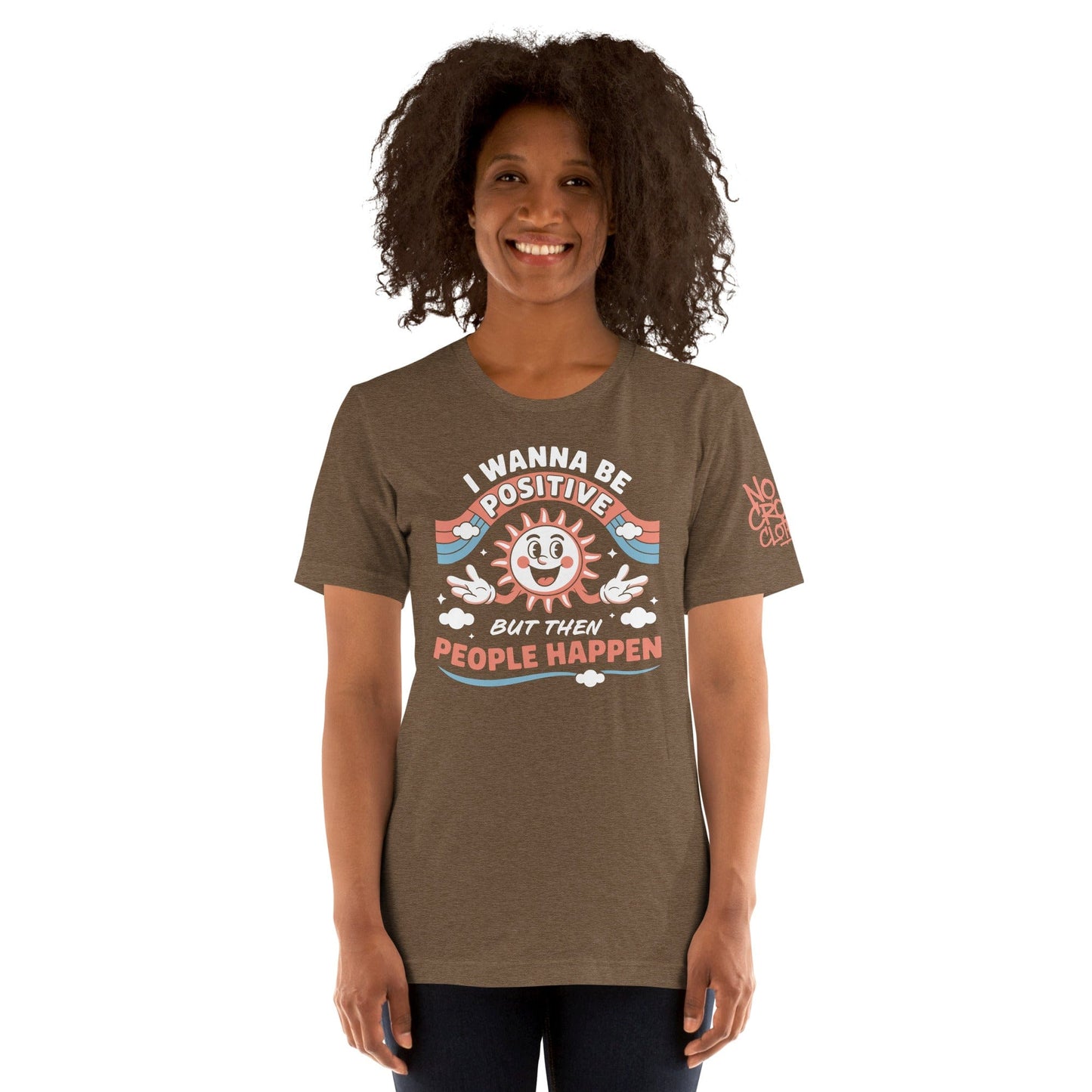 Brown t-shirt with a retro smiling sun design and the funny phrase “I Wanna Be Positive But Then People Happen,” featuring vintage-style colors and clouds...model